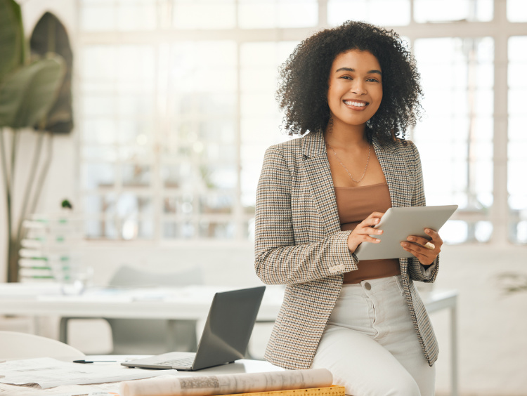 Happy businesswoman using a digital tablet. Young leading businesswoman using a wireless tablet.
